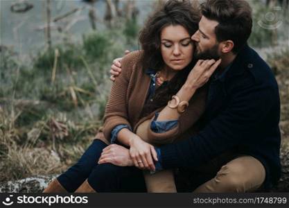 portrait of two caucasian lovers. Young couple is hugging on autumn day outdoors. A bearded man and curly woman in love. Valentine’s Day. Concept of love and family. portrait of two caucasian lovers. Young couple is hugging on autumn day outdoors. A bearded man and curly woman in love. Valentine’s Day. Concept of love and family.