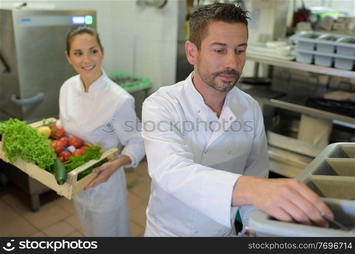 portrait of two chefs with vegetables