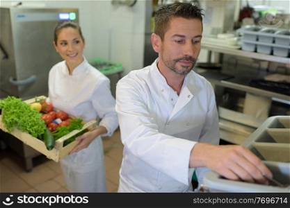portrait of two chefs with vegetables