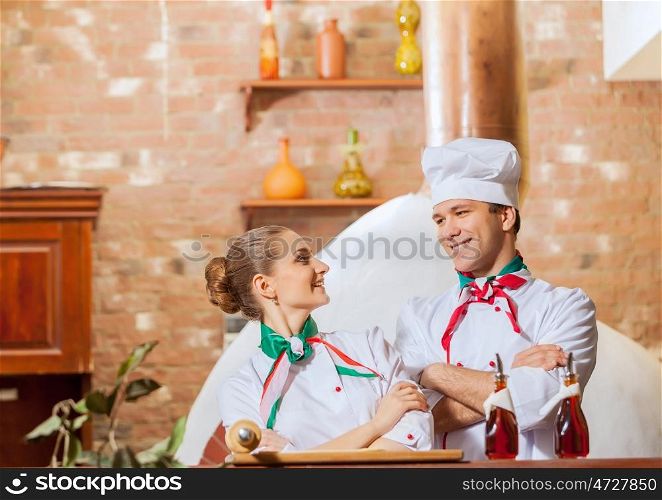 Portrait of two cooks with crossed arms. Portrait of two cooks with crossed arms looking at the camera