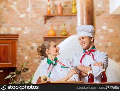 Portrait of two cooks with crossed arms. Portrait of two cooks with crossed arms looking at the camera