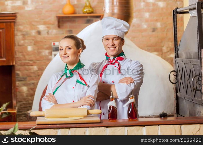 Portrait of two cooks with crossed arms. Portrait of two cooks with crossed arms looking at the camera