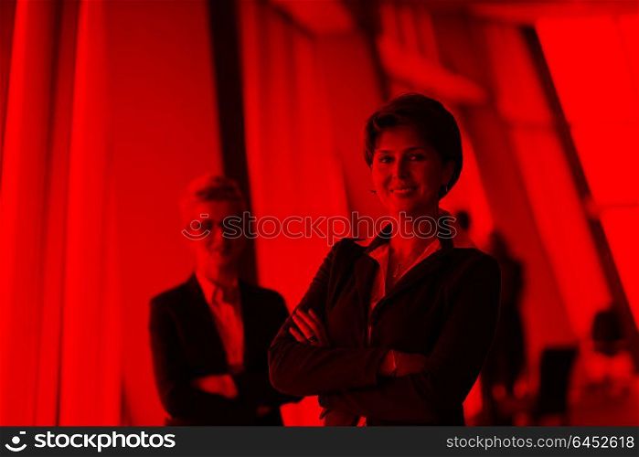 portrait of two corporate business woman at modern bright office interior standing in group as team
