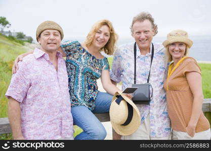 Portrait of two couples smiling in a park