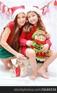 Portrait of two cute santa sisters