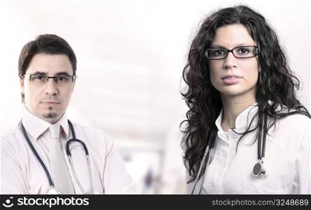 Portrait of two determined young doctors, taken on the hospital corridor.