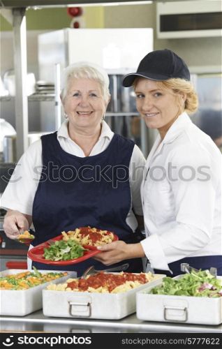Portrait Of Two Dinner Ladies In School Cafeteria