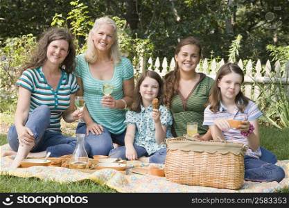 Portrait of two families having picnic in a park
