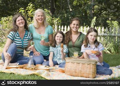 Portrait of two families having picnic in a park