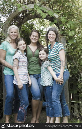 Portrait of two families standing together in a park