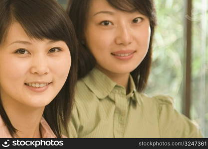 Portrait of two female office workers smiling in an office