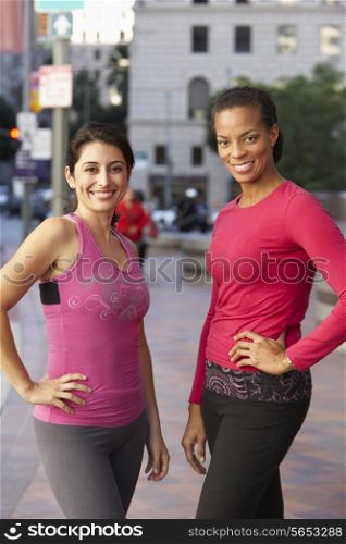 Portrait Of Two Female Runners On Urban Street