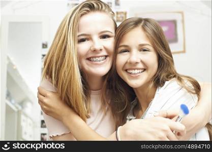 Portrait Of Two Female Teenage Friends In Bedroom