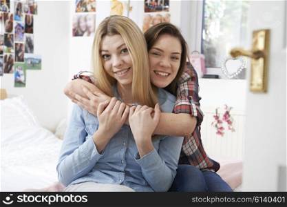 Portrait Of Two Female Teenage Friends In Bedroom
