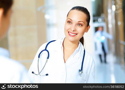 Portrait of two friendly female doctors in hospital discussing something