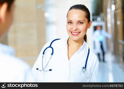 Portrait of two friendly female doctors. Portrait of two friendly female doctors in hospital discussing something