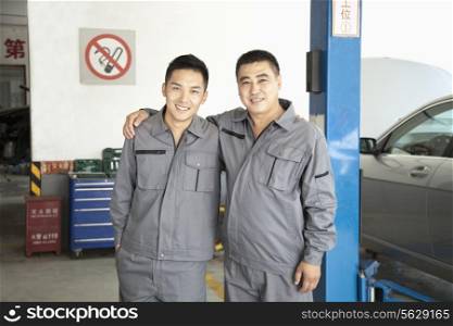 Portrait of Two Garage Mechanics