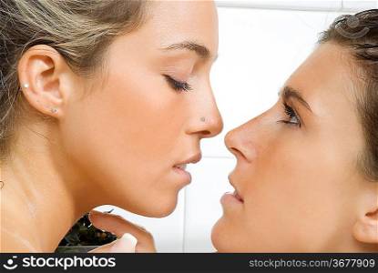 portrait of two girls i act to kiss each others