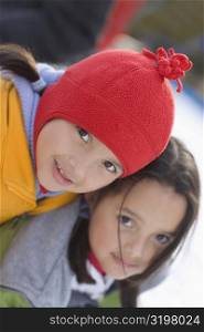 Portrait of two girls in warm clothing