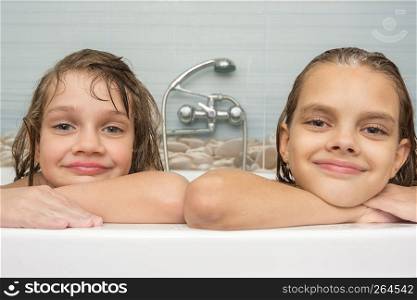 Portrait of two girls taking a bath