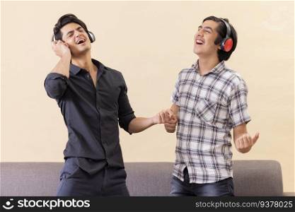 Portrait of two happy teenage boys listening to music and gesturing