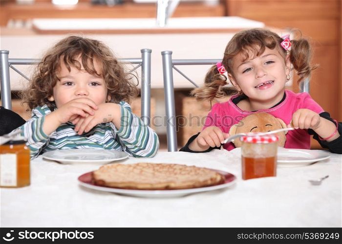 portrait of two kids at breakfast