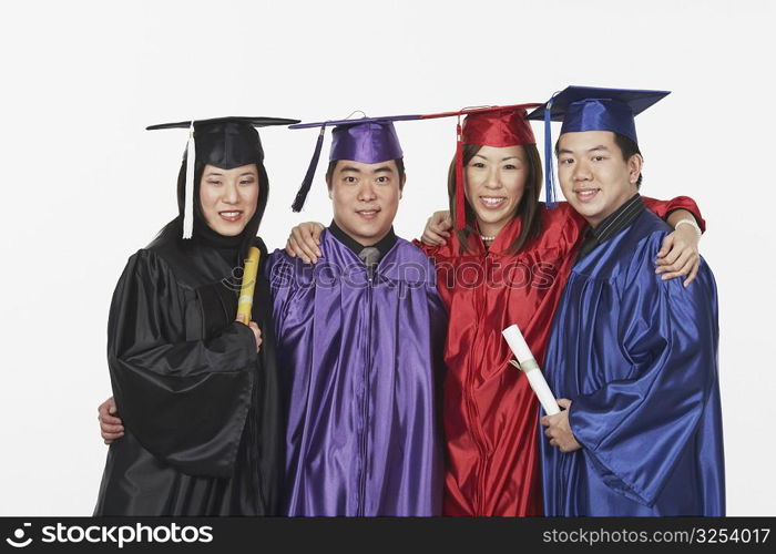 Portrait of two male and two female graduates