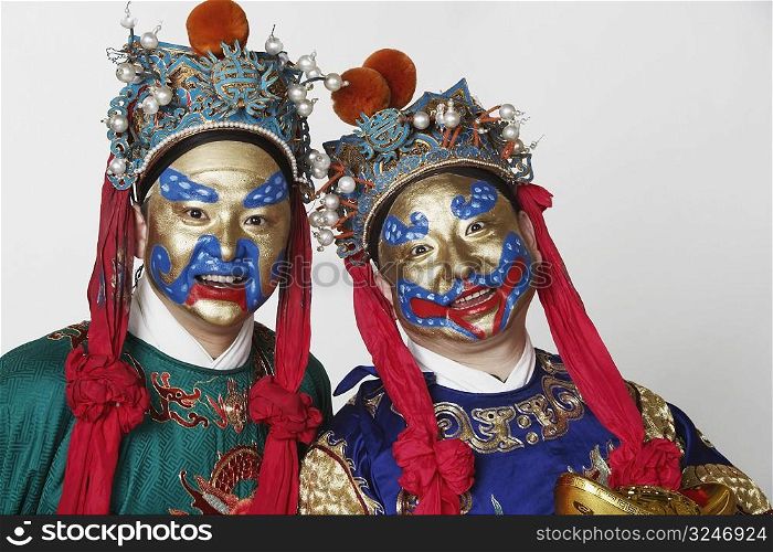 Portrait of two male Chinese opera performers smiling