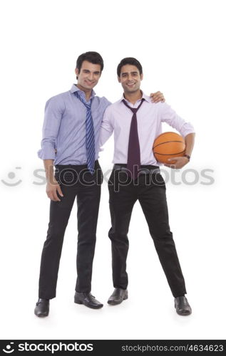 Portrait of two male executives with a basketball