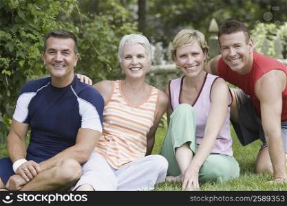 Portrait of two mature couples smiling in a park