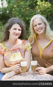Portrait of two mature women holding cold coffee cups