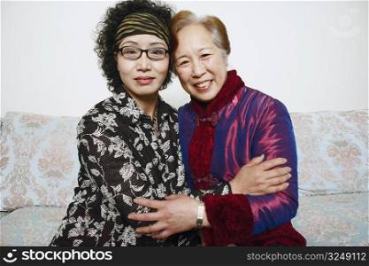 Portrait of two mature women hugging each other