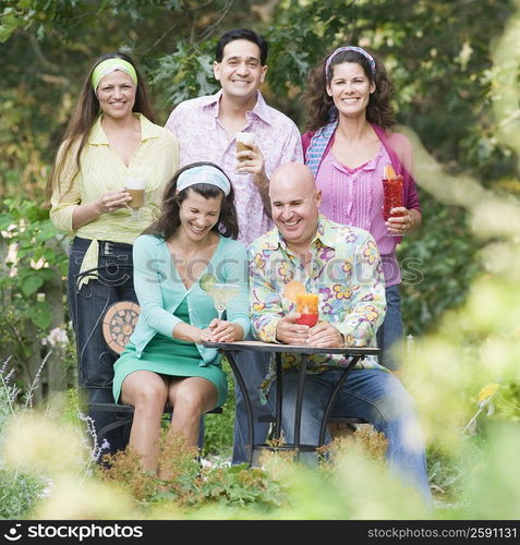 Portrait of two mature women smiling with her friends in a garden