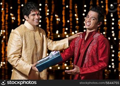 Portrait of two men exchanging gifts