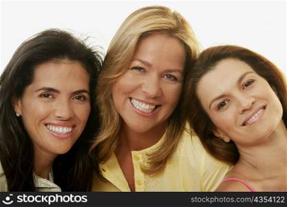 Portrait of two mid adult women and a mature woman smiling