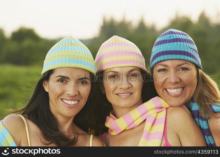Portrait of two mid adult women and a mature woman smiling