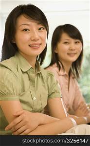 Portrait of two office workers smiling in an office