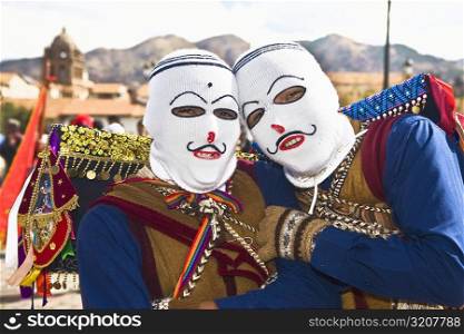 Portrait of two people wearing traditional costumes, Cuzco, Peru