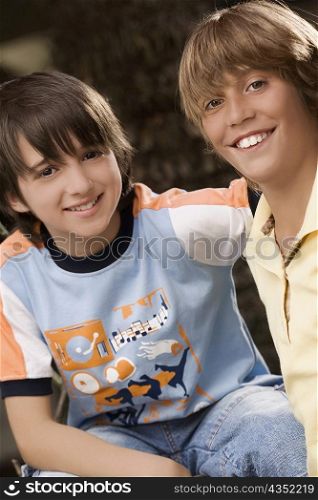 Portrait of two schoolboys smiling together