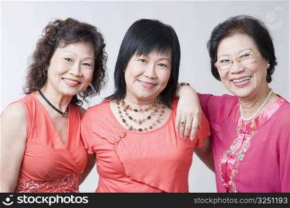 Portrait of two senior women and a mature woman smiling