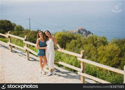 Portrait of two sisters in front of the Gatzelugatxe Island in Vizcaya, Spain