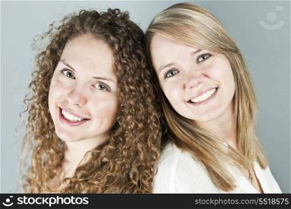 Portrait of two smiling women. Portrait of two pretty caucasian young women