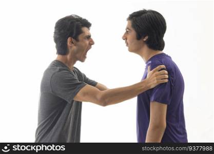 Portrait of two teenage boys fighting against pain background