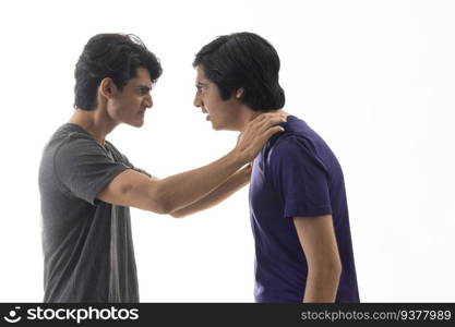 Portrait of two teenage boys fighting against pain background