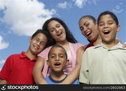 Portrait of two teenage girls and three boys laughing