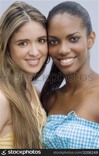 Portrait of two teenage girls smiling cheek to cheek