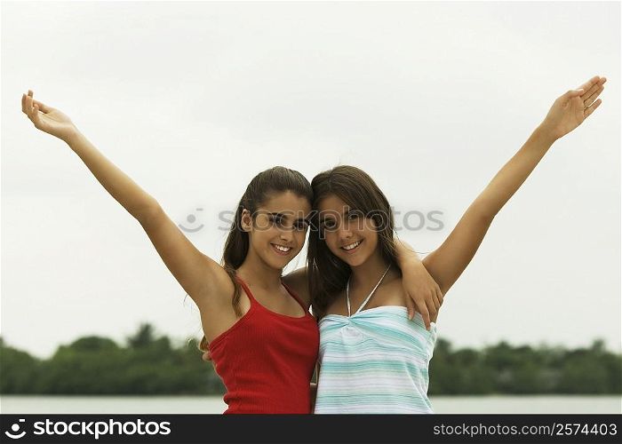 Portrait of two teenage girls with their arms around each other