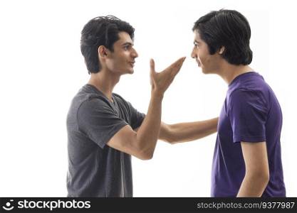 Portrait of two teenagers having argument and gesturing