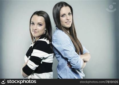 portrait of two teenagers. two teenagers with folded arms