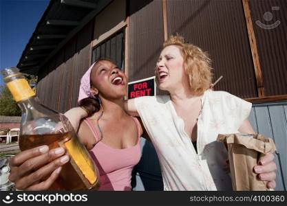 Portrait of two trashy drunk women outdoors